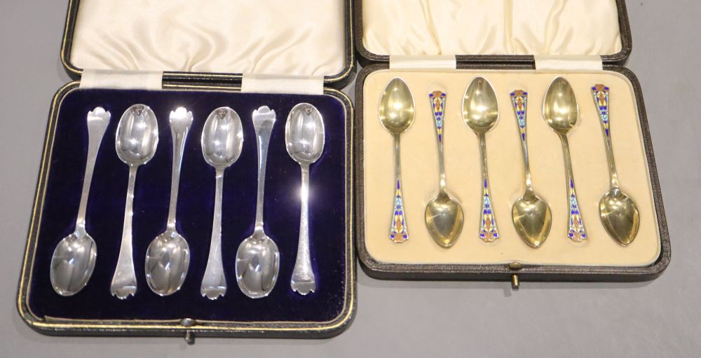 Two cased sets of six silver teaspoons/coffee spoons including silver gilt and enamel by Levi & Salaman, Birmingham, 1927,